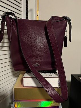 Coach Jude Duffle Leather Bag in a berry or burgundy